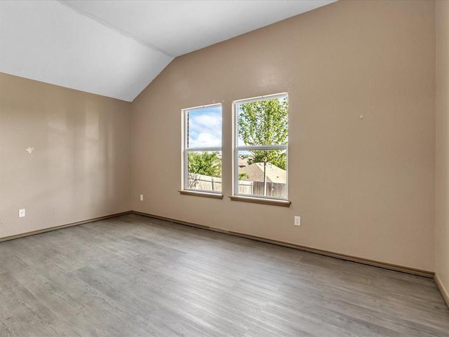 Additional living space with baseboards, wood finished floors, and lofted ceiling | Image 8