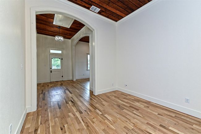 Foyer and Dining with wood ceiling, arched walkways, light wood-style floors, and ornamental molding | Image 15