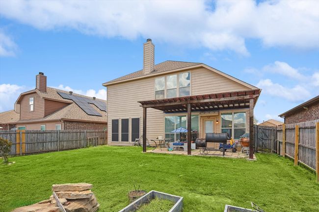 Back of house featuring a patio area, a pergola, a fenced backyard, and a chimney | Image 33