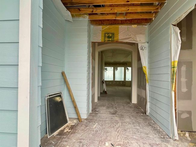 A unique architectural detail you won’t find just anywhere: the covered entryway creates a grand sense of arrival while providing protected outdoor storage for beach gear, fishing poles, or paddleboards — everything your guests or family need for the ultimate coastal escape. | Image 25