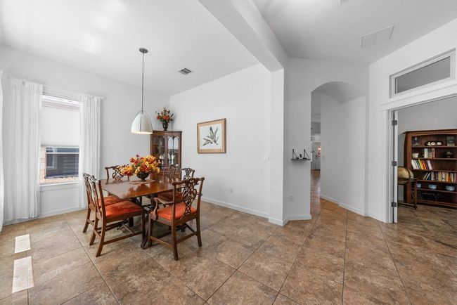 Dining area featuring arched walkways, baseboards, and visible vents | Image 4