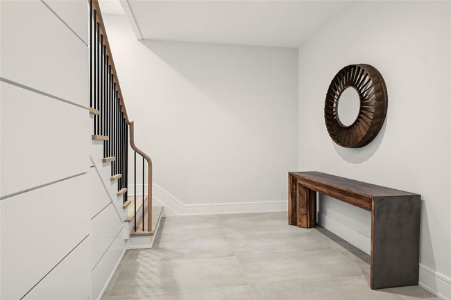Foyer entrance with baseboards, stairs, and finished concrete floors | Image 31