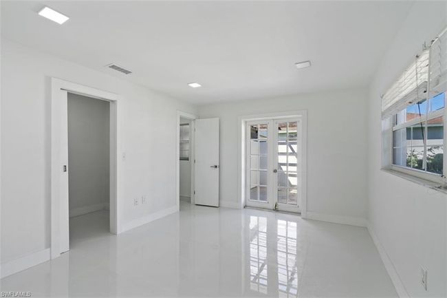Empty room featuring baseboards, visible vents, and french doors | Image 14