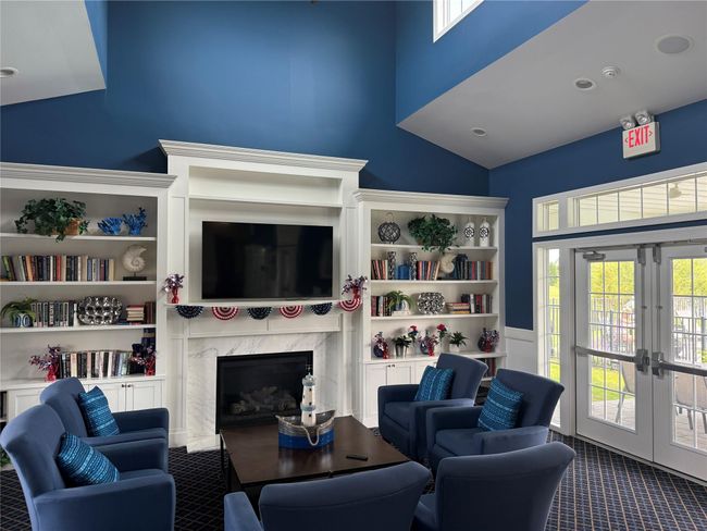 Carpeted living area with french doors, a premium fireplace, and lofted ceiling | Image 19