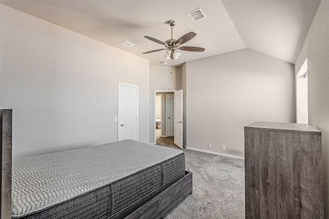 Unfurnished bedroom featuring carpet flooring, lofted ceiling, and a ceiling fan | Image 35