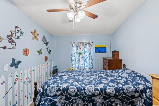 Bedroom featuring ceiling fan | Image 14