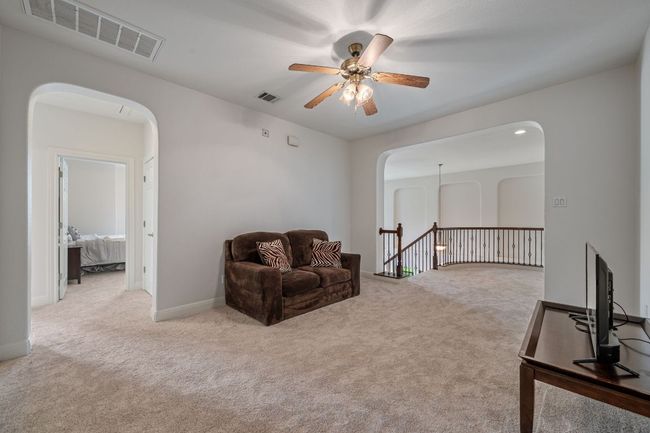 Living area featuring visible vents, arched walkways, and a ceiling fan | Image 26