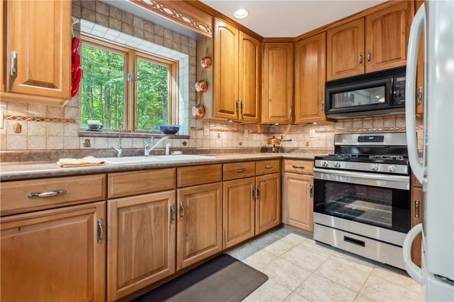 Kitchen with beautiful cabinets and easy flow to dining and living areas | Image 6