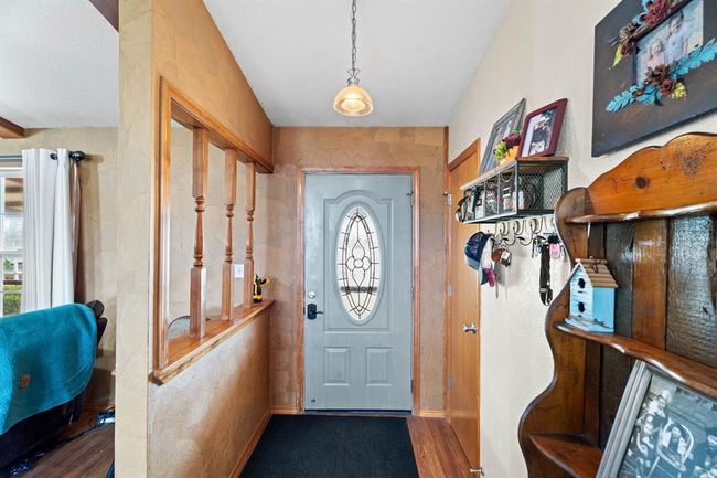Foyer featuring baseboards and wood finished floors | Image 14