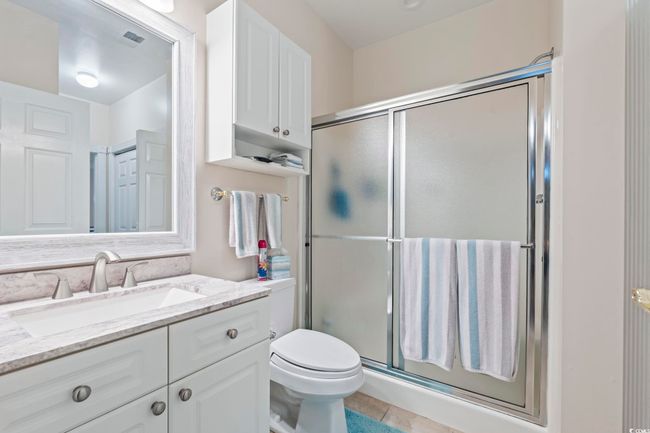 Full bathroom featuring vanity, a stall shower, and tile patterned flooring | Image 8