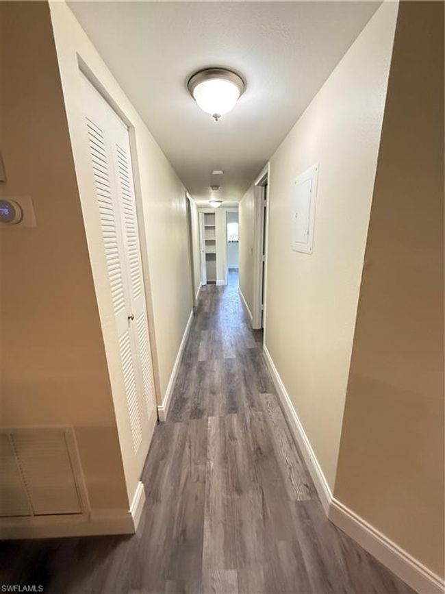 Hall with dark wood finished floors and baseboards | Image 7