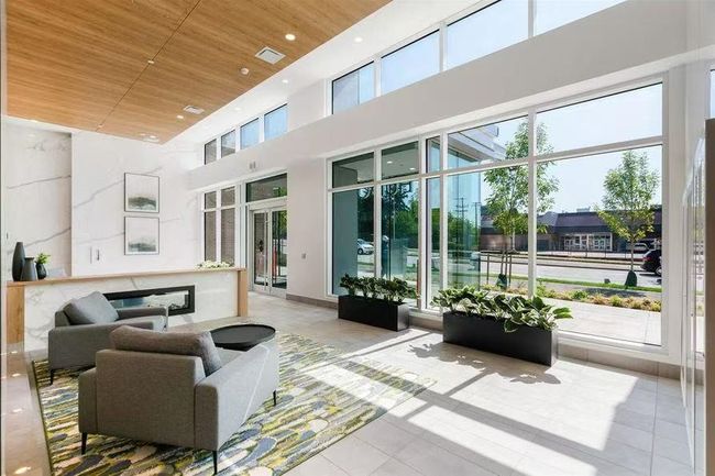 Community lobby featuring wooden ceiling, a towering ceiling, and recessed lighting | Image 6