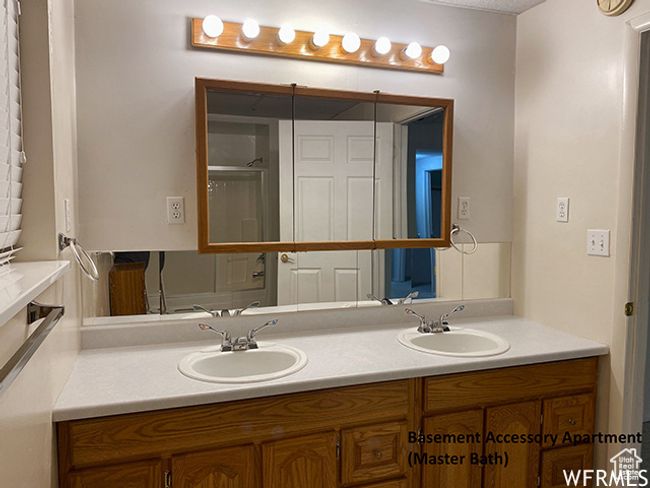 Bathroom with double vanity, a sink, and a shower with shower door | Image 55