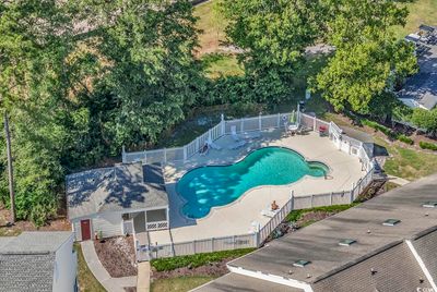 View of swimming pool with a patio | Image 3