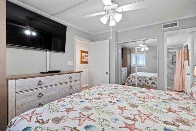 Bedroom featuring crown molding, a closet, ceiling fan, and visible vents | Image 7