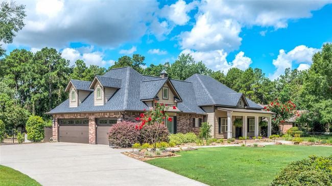 Spacious 3-car garage with additional driveway space for 5+ vehicles. | Image 5