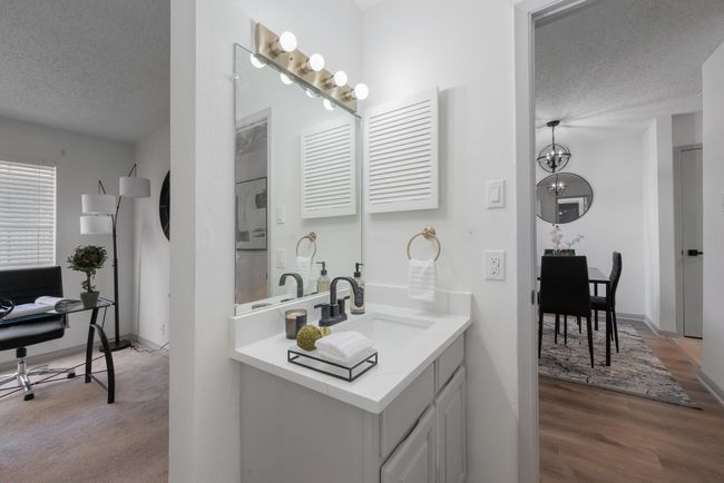 Bathroom featuring wood finished floors, baseboards, vanity, and a textured ceiling | Image 34