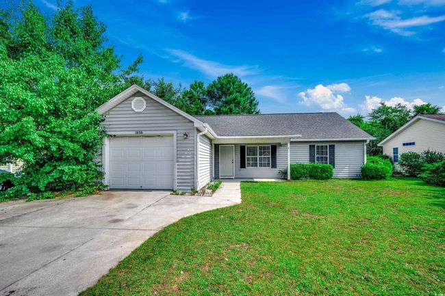 Ranch-style home featuring a garage, concrete driveway, a front yard, and roof with shingles | Image 39