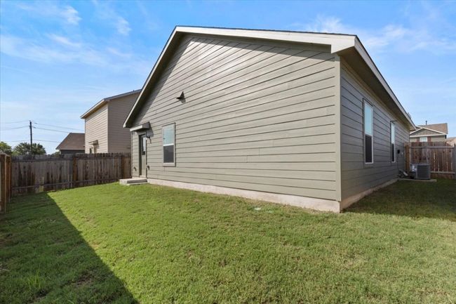 View of property exterior featuring a fenced backyard and a central air condition unit | Image 17