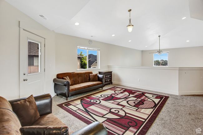 Carpeted living room with recessed lighting and a ceiling fan | Image 21