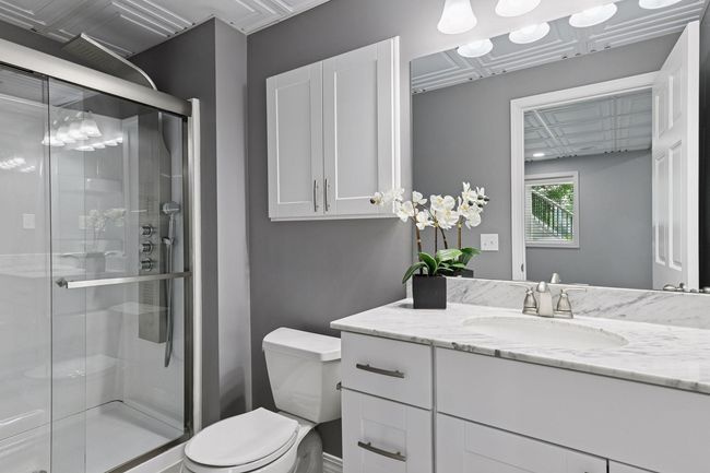 Lower level bathroom features quartz counters and walk in shower | Image 25