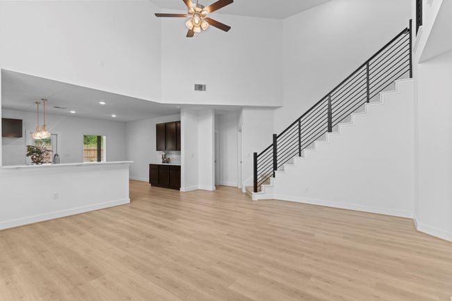 An entertainer’s dream—this open-concept living room flows seamlessly into the gourmet kitchen, with beautiful sightlines, modern lighting, and elegant finishes throughout. **Image Representative of Plan Only and May Vary as Built**. | Image 8