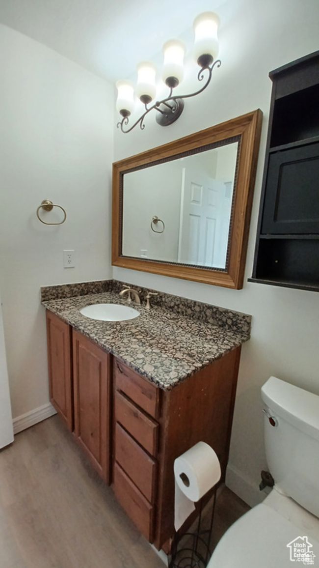 Half bathroom with vanity and wood finished floors | Image 20