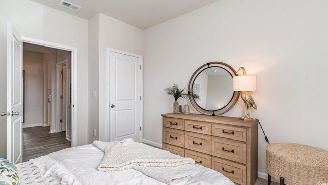 Bedroom with baseboards and wood finished floors | Image 19