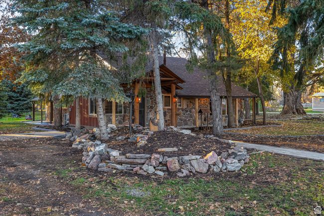 View of front of property featuring roof with shingles and stone siding | Image 4
