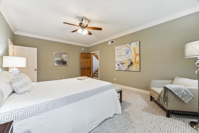 From the far corner of the room, you see the door to the entryway and the primary suite bath to the left. | Image 19