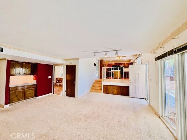 Den area shows bar, kitchen, and slider to patio | Image 19