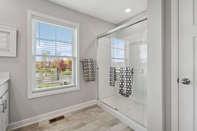 (Photo of decorated model, actual home's finishes will vary) An extension of the owner's suite, this private bath contains a double-vanity, a shower and a private water closet. | Image 15