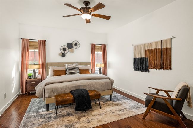 Bedroom with dark wood finished floors and a ceiling fan | Image 13
