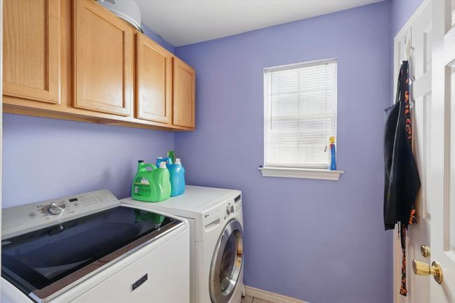 Laundry room with washing machine and clothes dryer, baseboards, and cabinet space | Image 18