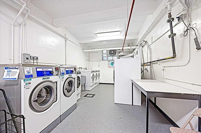 Communal laundry room with washer and clothes dryer | Image 20
