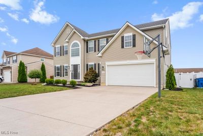 View of front of home featuring a garage and a front yard | Image 2