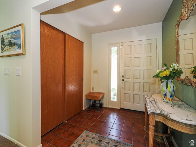 Foyer entrance with dark tile patterned floors and baseboards | Image 7
