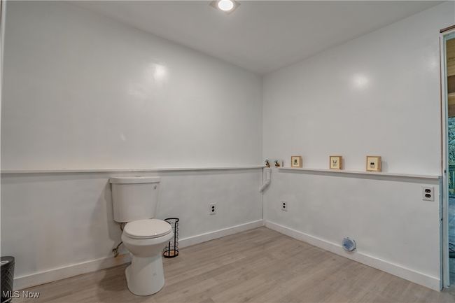 Bathroom featuring wood finished floors, toilet, and baseboards | Image 22