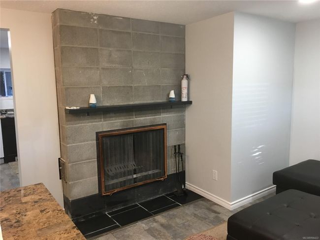 Room details with a fireplace and baseboards | Image 19