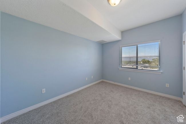 Carpeted empty room featuring baseboards | Image 9