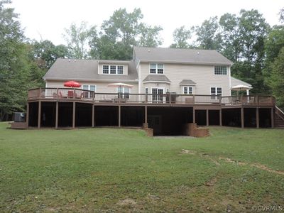 Rear view of property featuring a lawn and a deck | Image 3