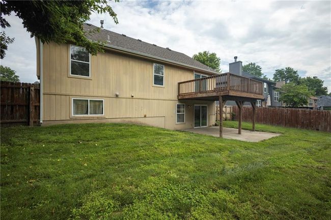 Back of house featuring a patio area, a wooden deck, and roof with shingles | Image 36