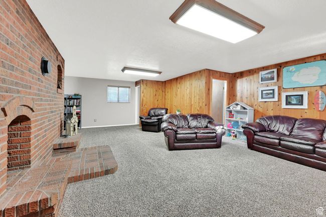 Living room featuring wood walls and carpet | Image 27