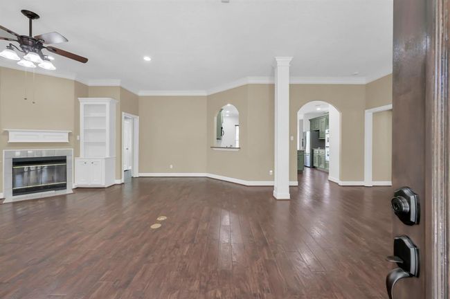 entering in the front door. Fireplace on the left as well as the built in shelving. | Image 8
