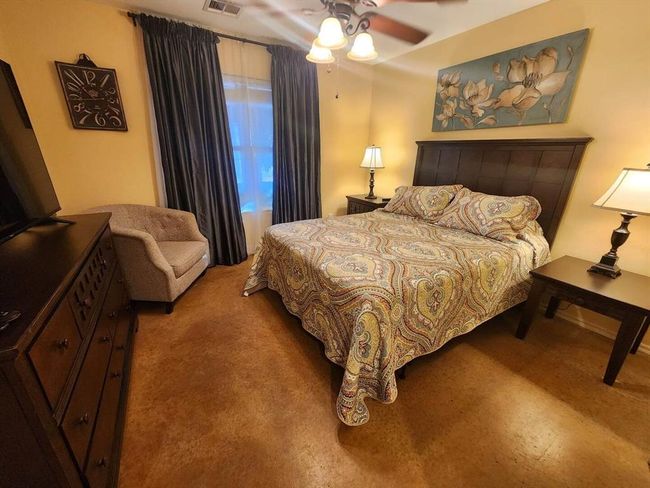 Carpeted bedroom with a ceiling fan | Image 21