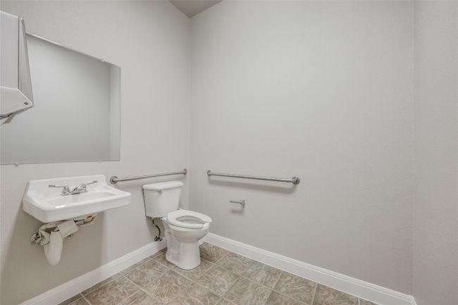 Half bath featuring tile patterned floors, toilet, baseboards, and a sink | Image 32