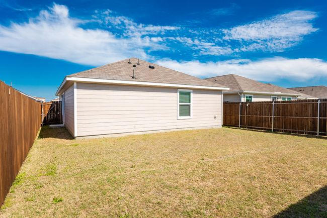 Rear view of house featuring a yard and a fenced backyard | Image 17