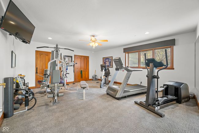 exercise room featuring baseboards, recessed lighting, and a ceiling fan | Image 99