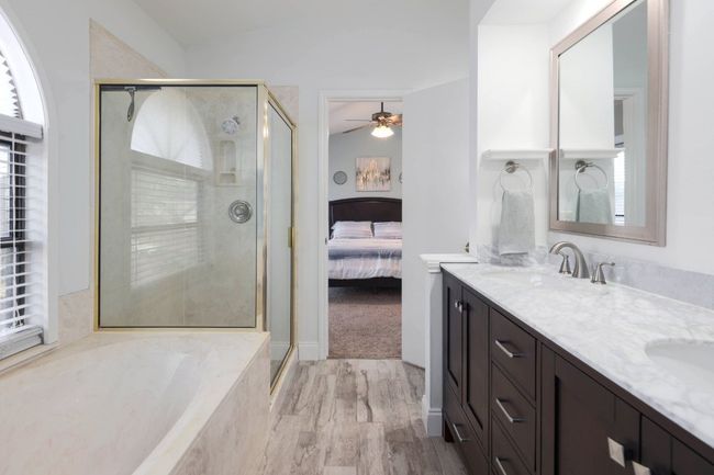 The garden tub invites you to unwind with a long, soothing soak, while the separate shower offers a refreshing way to start your day or cool off after a workout | Image 20