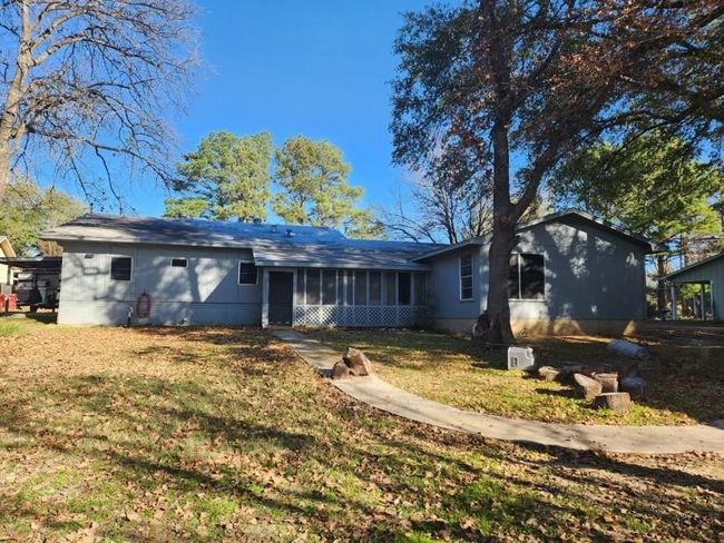 View of front of house with a sunroom and a front lawn | Image 22